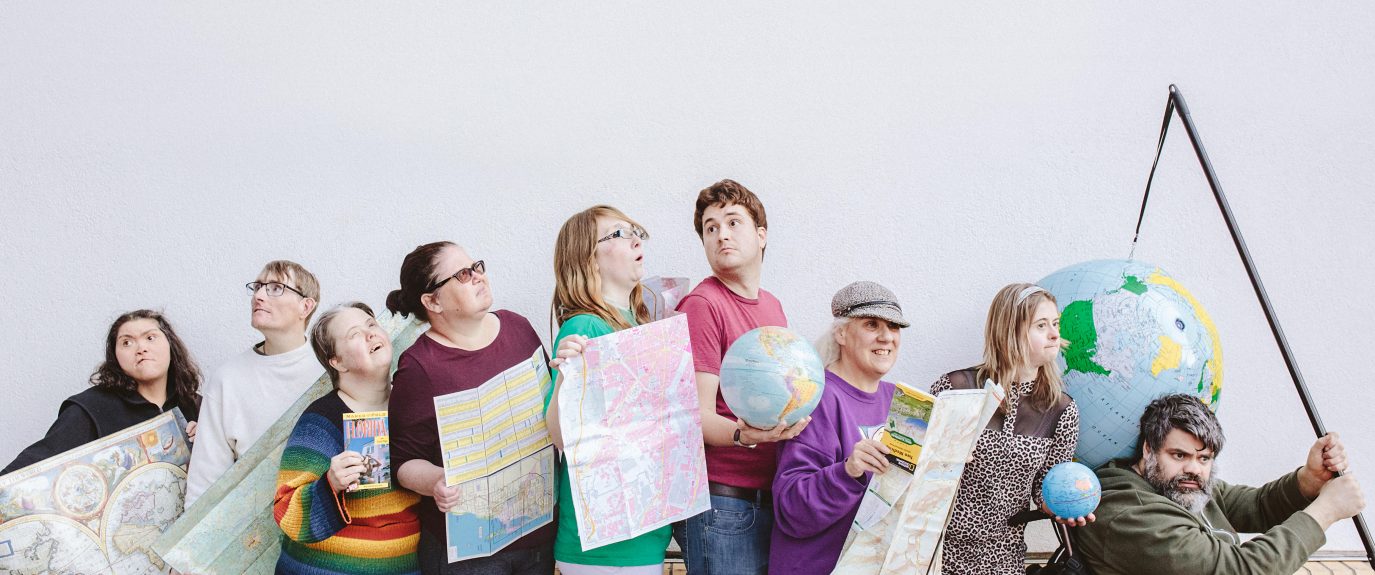 Photo of a group of people holding maps.