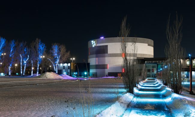 Photo of TOHU outside at night in the winter.